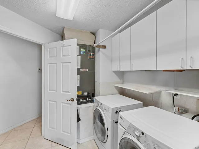 a view of a livingroom with bathroom and front door