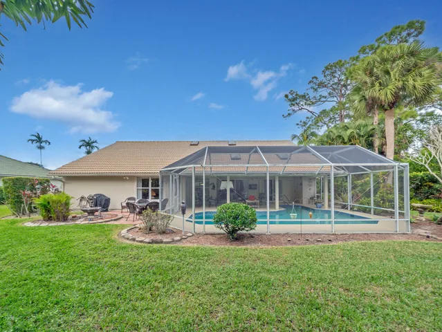 an aerial view of a house with a yard and lake view