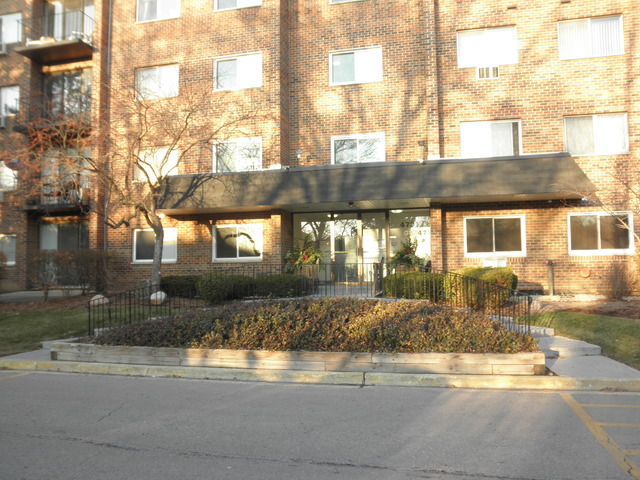 4731 St Joseph Creek Road, Unit 3G Lisle, IL 60532 - Photo 1 of 12 a front view of a house with a yard