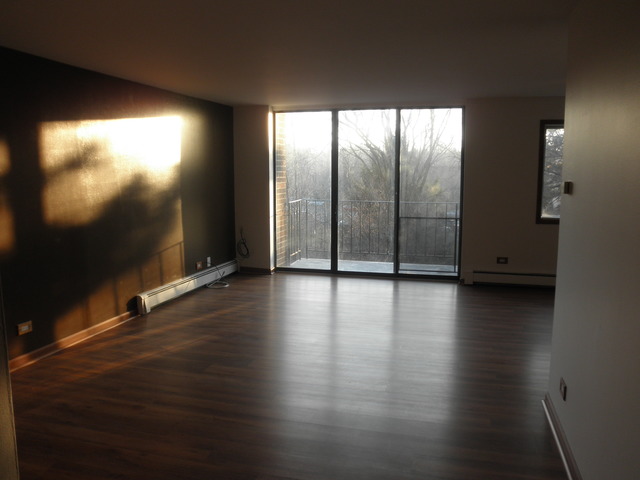 4731 St Joseph Creek Road, Unit 3G Lisle, IL 60532 - Photo 2 of 12 a view of room with hardwood floor and large window