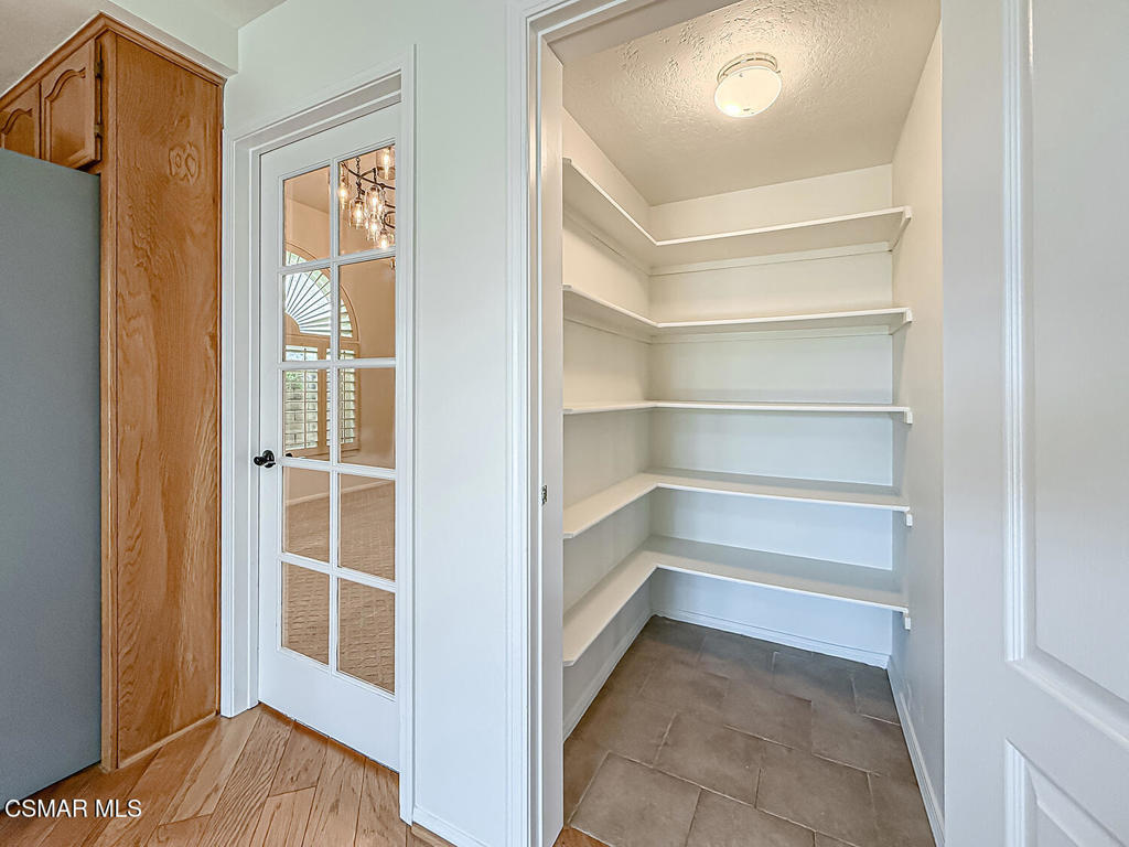 12057 Falcon Crest Way Porter Ranch, CA 91326 - Photo 20 of 86 a view of an empty room with cabinet and a window