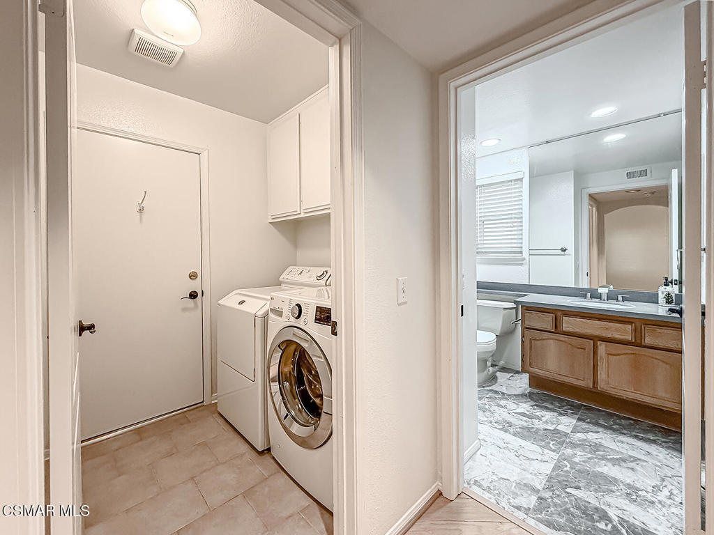12057 Falcon Crest Way Porter Ranch, CA 91326 - Photo 22 of 86 a view of a hallway with washer and dryer