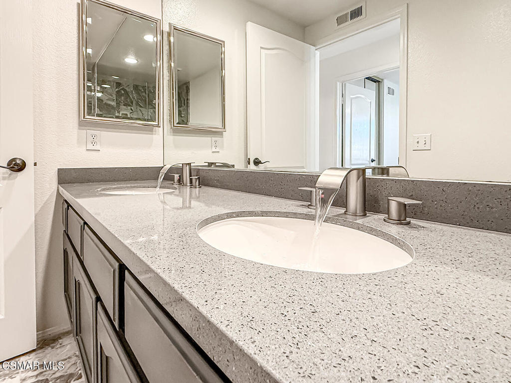 12057 Falcon Crest Way Porter Ranch, CA 91326 - Photo 42 of 86 a bathroom with a sink and a mirror