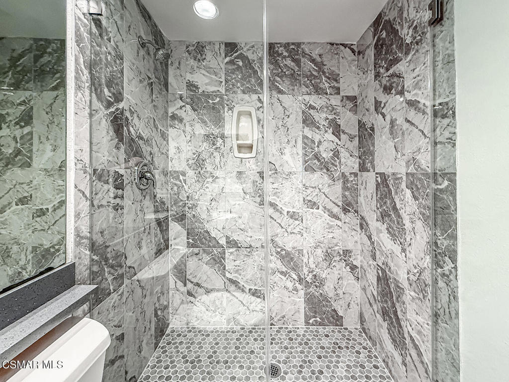 12057 Falcon Crest Way Porter Ranch, CA 91326 - Photo 43 of 86 a bathroom with a toilet and a shower curtain