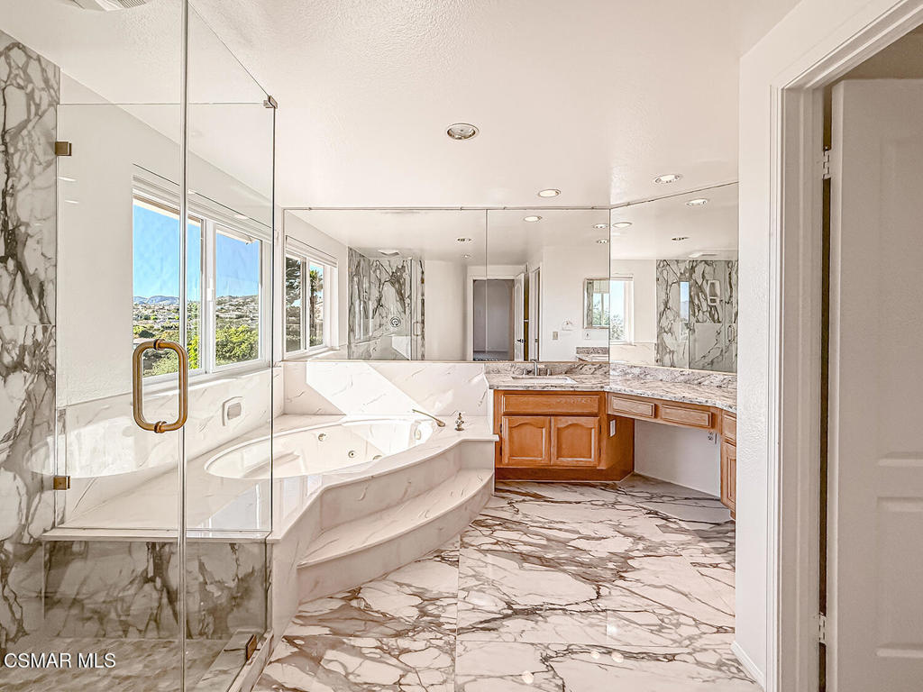 12057 Falcon Crest Way Porter Ranch, CA 91326 - Photo 51 of 86 a bathroom with a tub sink and mirror