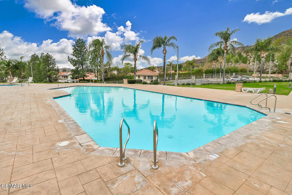 12057 Falcon Crest Way Porter Ranch, CA 91326 - Photo 65 of 86 a view of a swimming pool with a yard