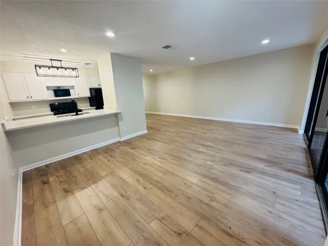 a view of a kitchen with a sink and cabinets