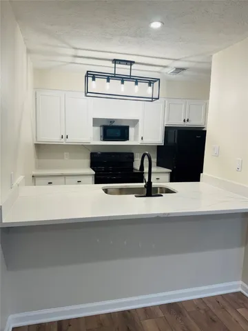a view of kitchen with cabinets and wooden floor