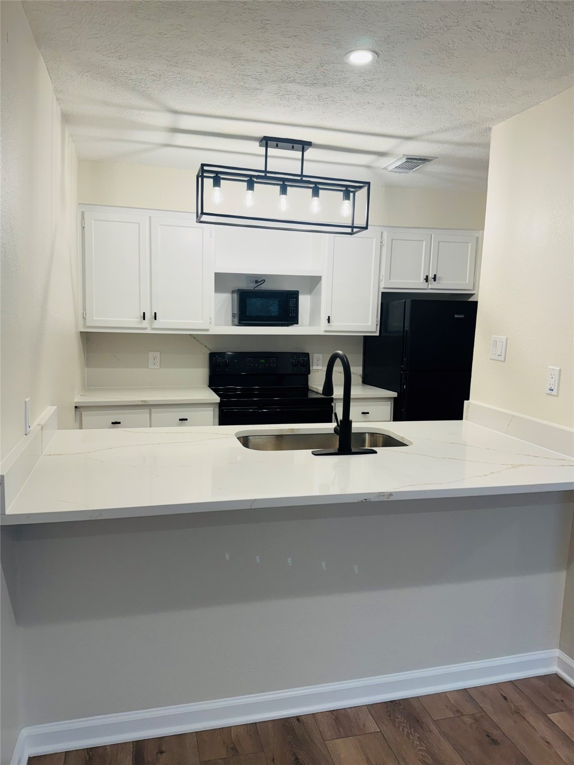 3900 Aspen Drive, Unit C104 Montgomery, TX 77356 - Photo 15 of 21 a view of kitchen with cabinets and wooden floor