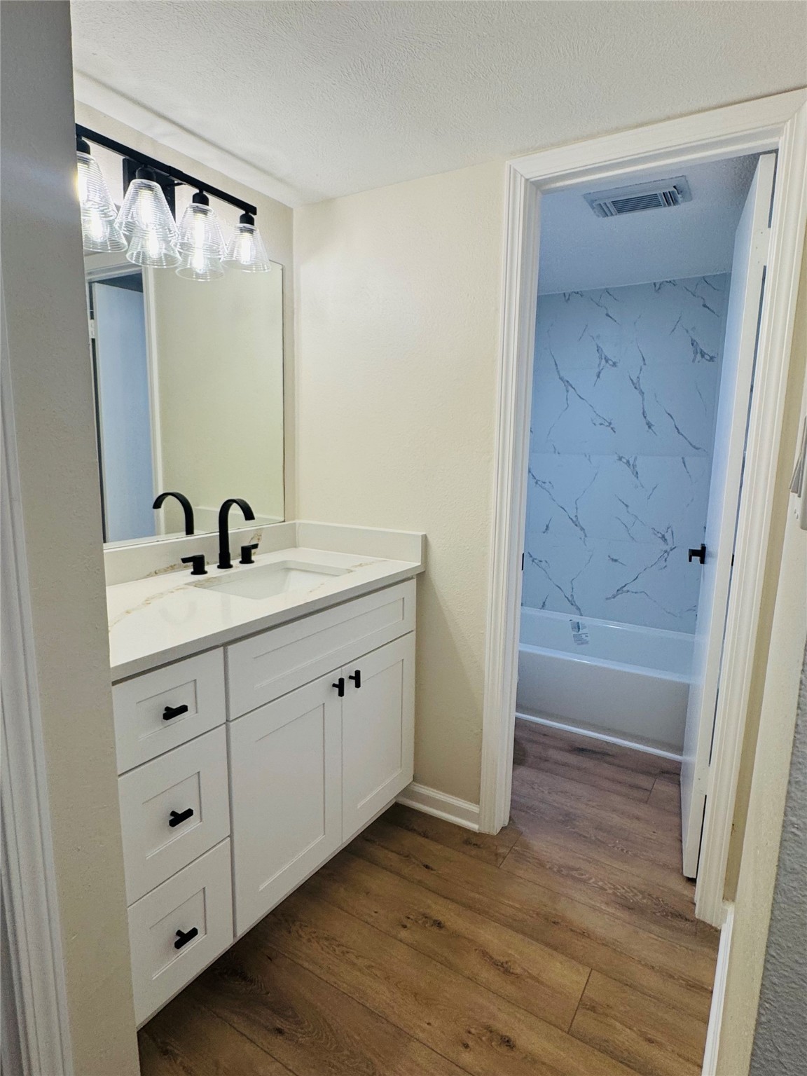 3900 Aspen Drive, Unit C104 Montgomery, TX 77356 - Photo 18 of 21 a bathroom with a double vanity sink and mirror