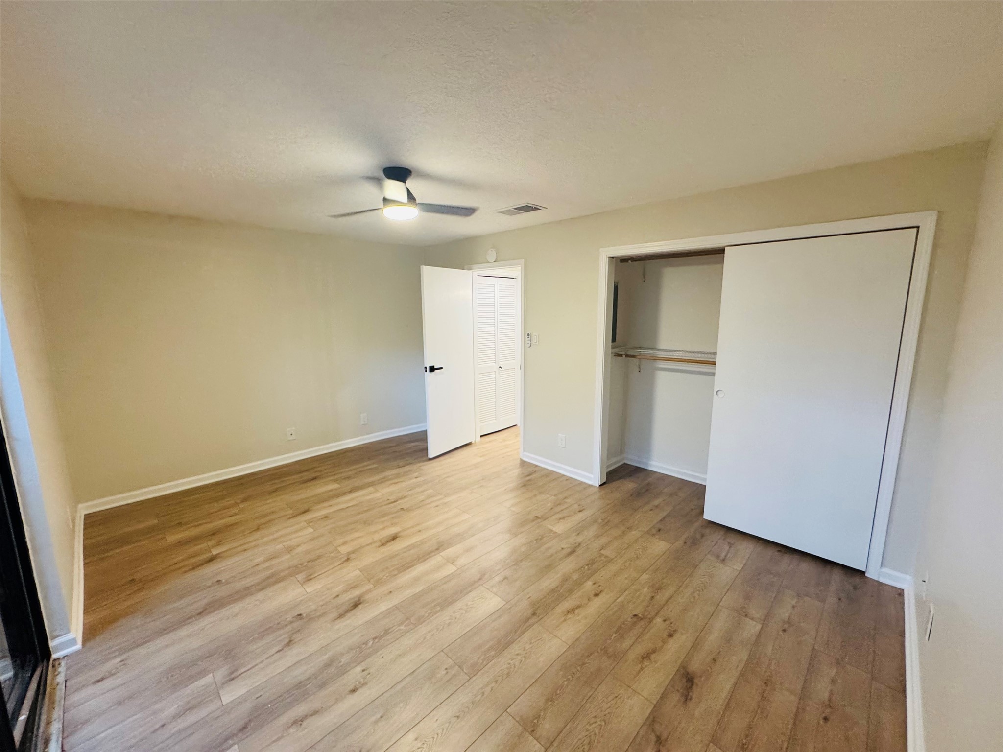 3900 Aspen Drive, Unit C104 Montgomery, TX 77356 - Photo 19 of 21 a view of empty room with wooden floor and fan