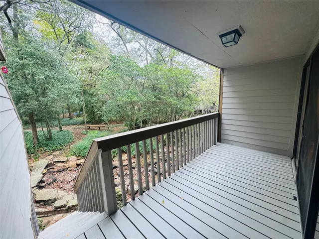 a balcony with wooden floor and outdoor space