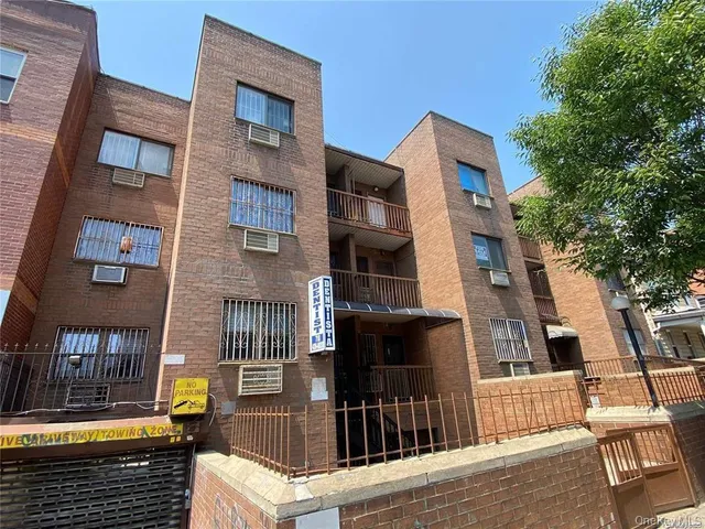 a view of a brick building with many windows
