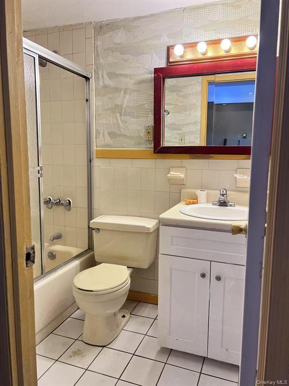 37-30 103rd Street, Unit 2B Queens, NY 11368 - Photo 7 of 8 a bathroom with a sink a toilet and shower