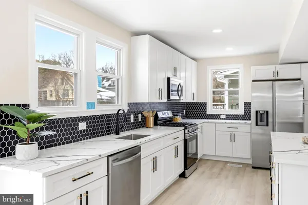 a kitchen with a sink stove and refrigerator