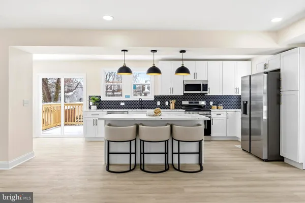 a kitchen with stainless steel appliances a refrigerator and a stove top oven
