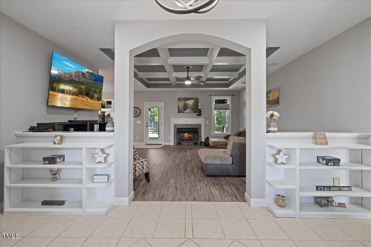 1005 Bellewood Farms Road Raleigh, NC 27603 - Photo 11 of 61 a living room with furniture a flat screen tv and a fireplace