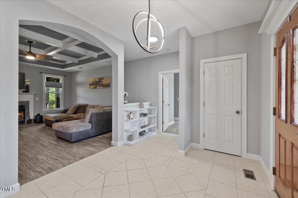 1005 Bellewood Farms Road Raleigh, NC 27603 - Photo 12 of 61 a living room with furniture a chandelier and a window