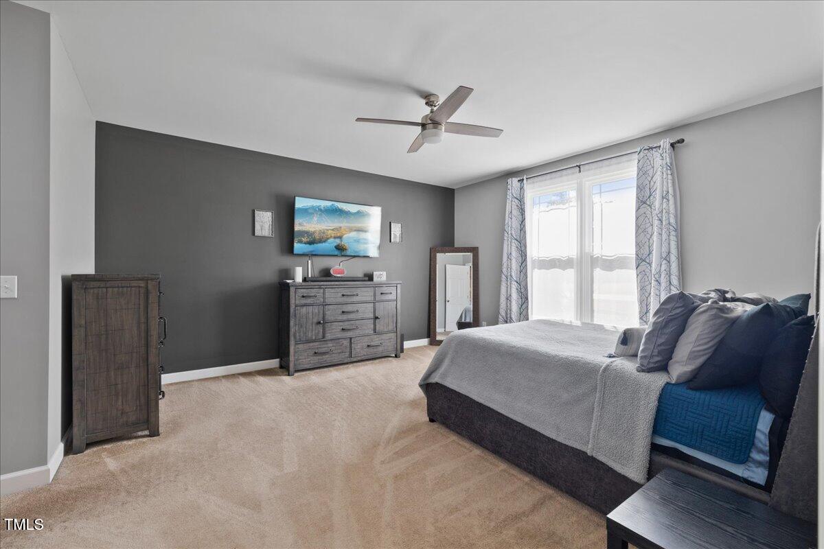1005 Bellewood Farms Road Raleigh, NC 27603 - Photo 13 of 61 a living room with a bed and furniture