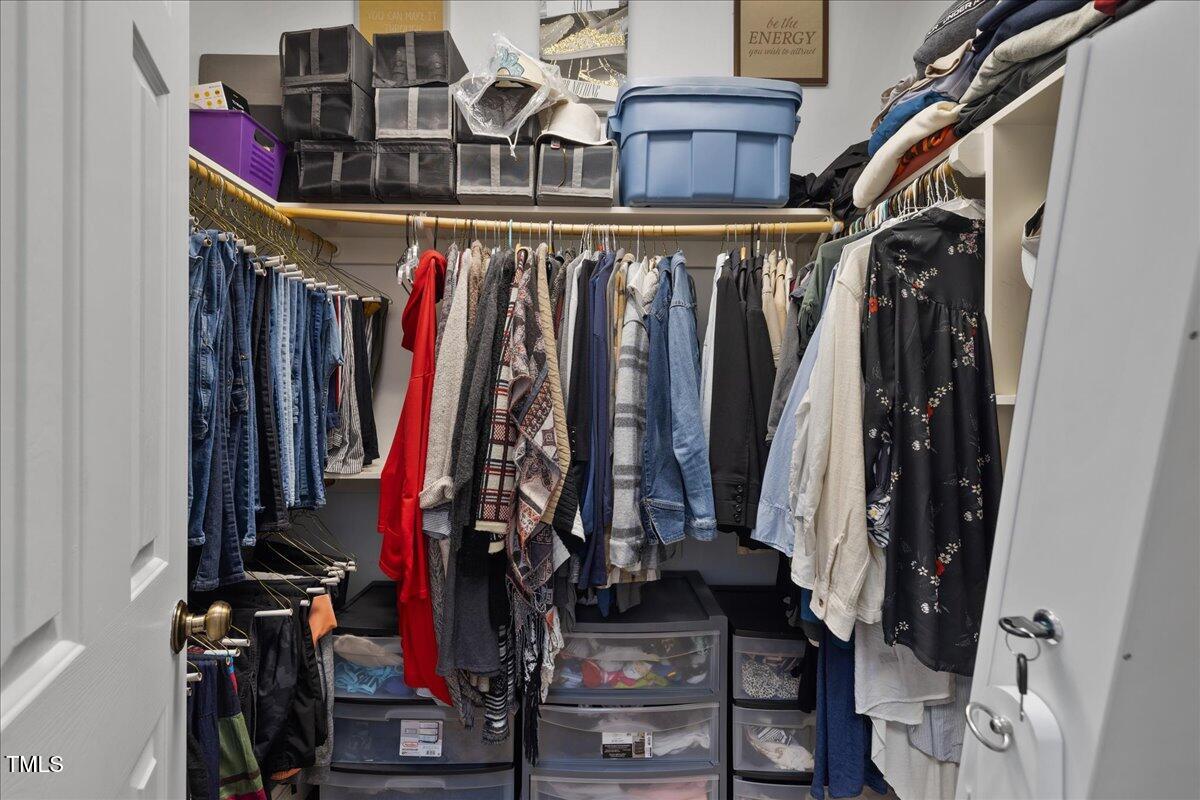 1005 Bellewood Farms Road Raleigh, NC 27603 - Photo 16 of 61 a view of walk in closet with clothes