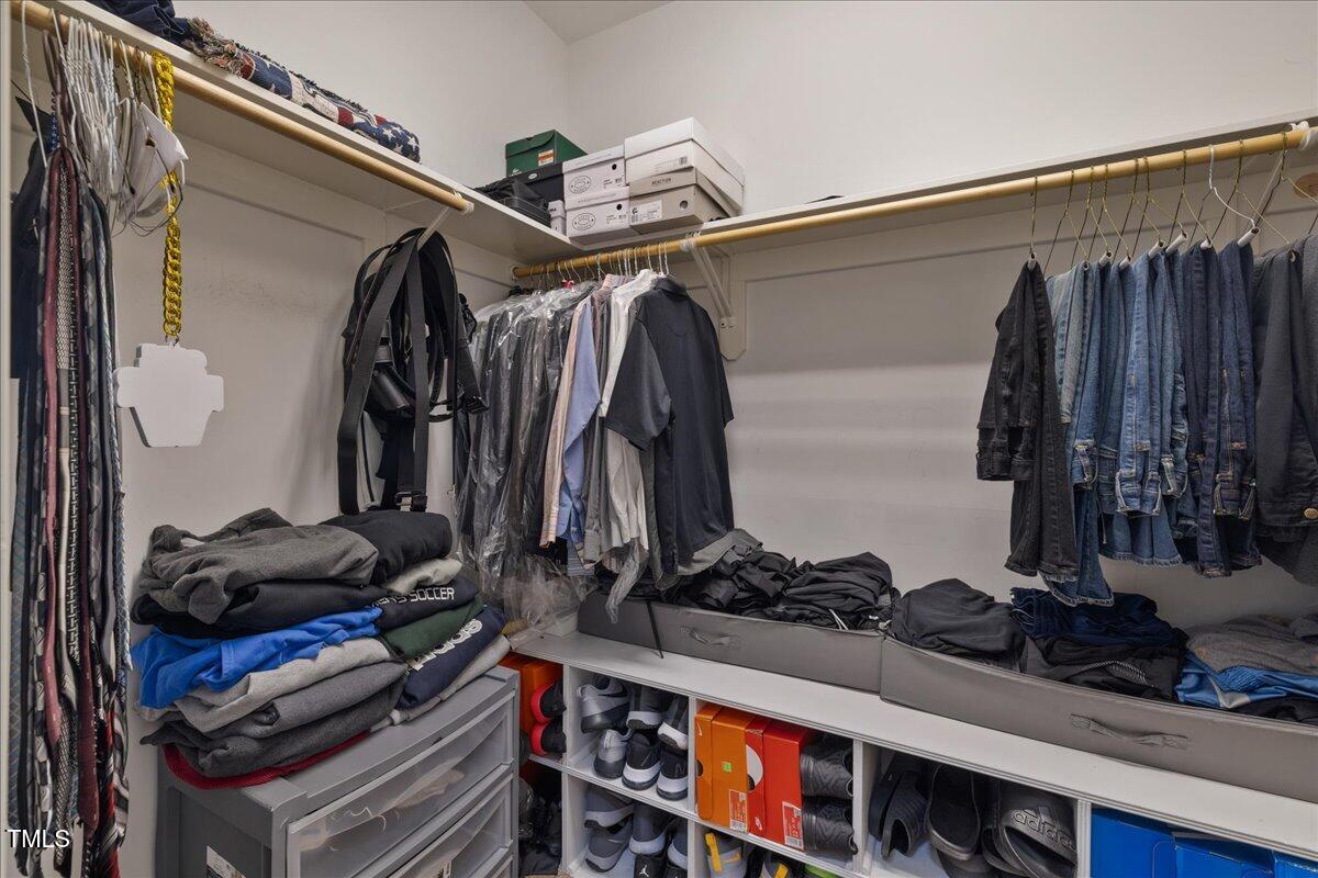 1005 Bellewood Farms Road Raleigh, NC 27603 - Photo 17 of 61 a view of walk in closet with clothes and shoes