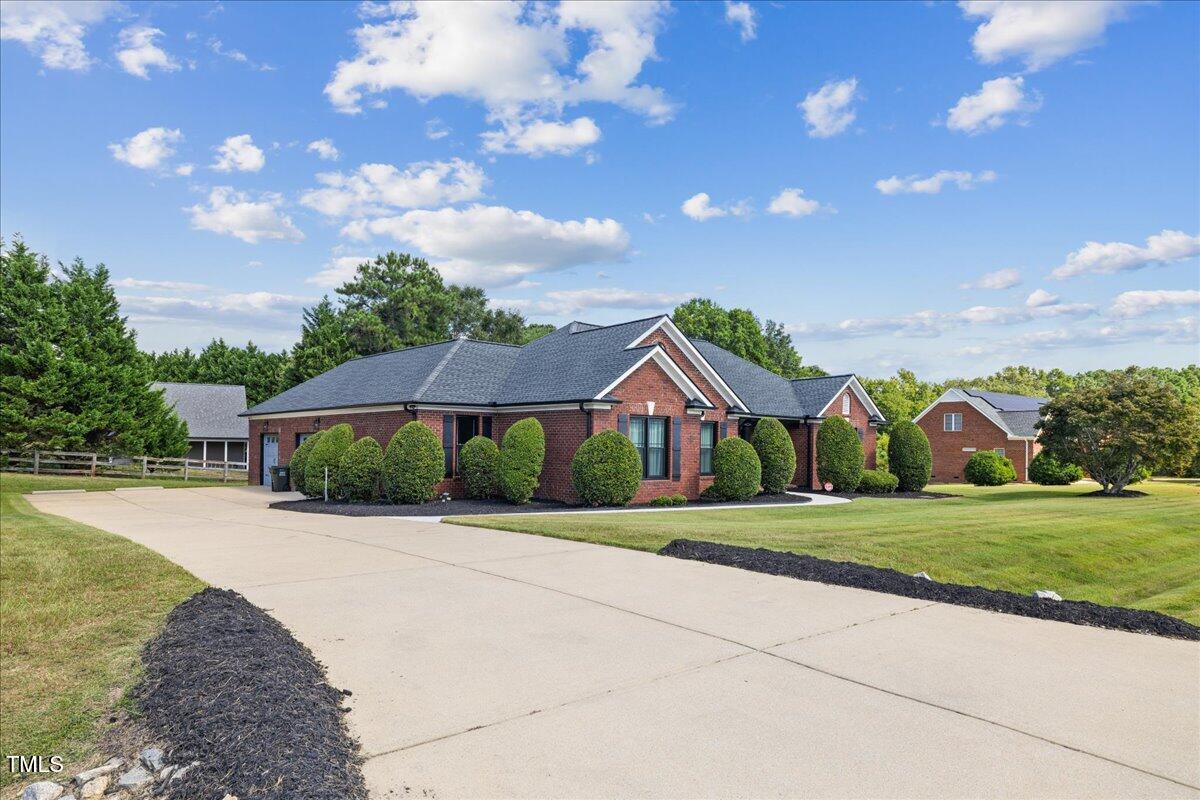 1005 Bellewood Farms Road Raleigh, NC 27603 - Photo 2 of 61 a front view of a house with a yard and trees