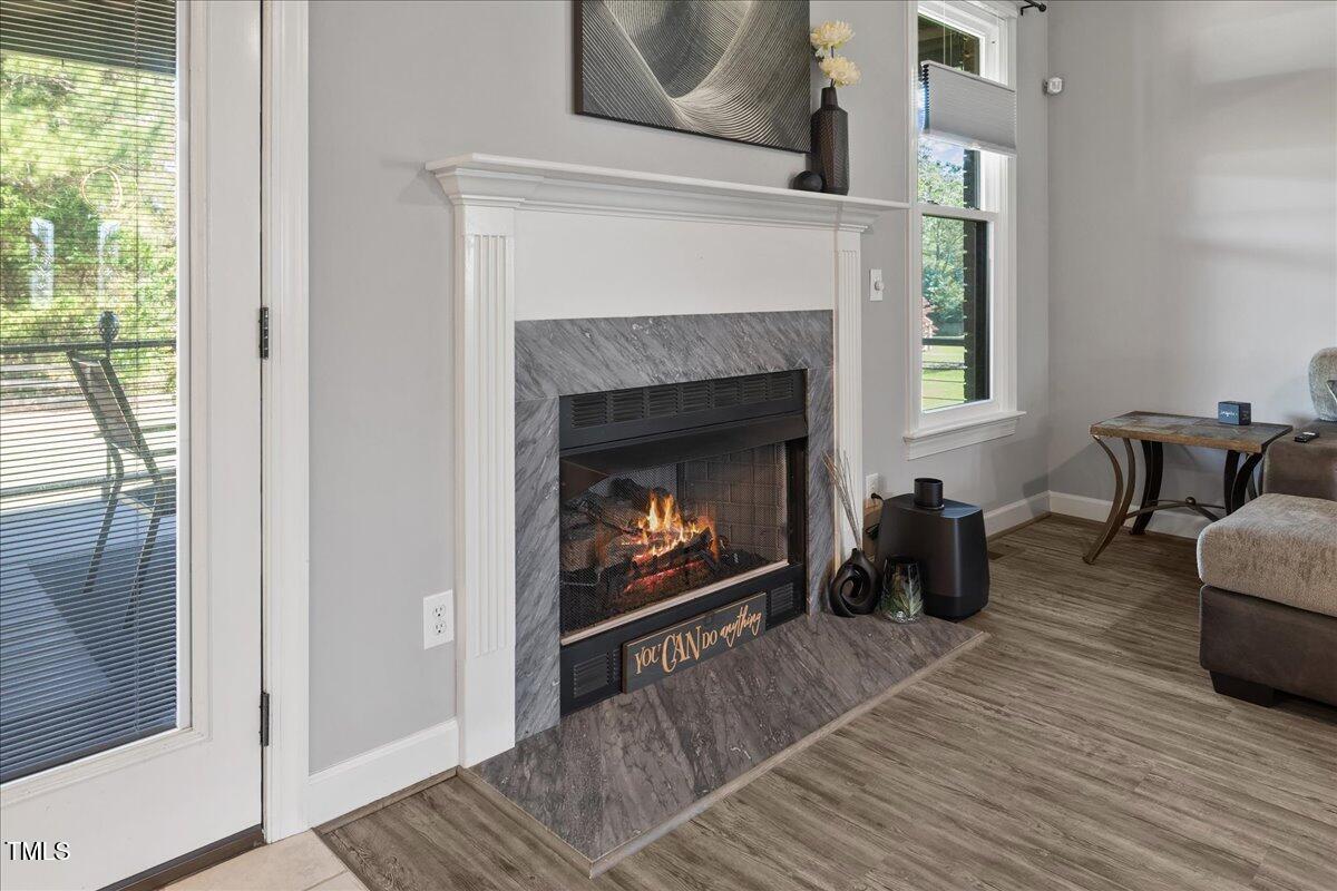 1005 Bellewood Farms Road Raleigh, NC 27603 - Photo 25 of 61 a living room with furniture and a fireplace