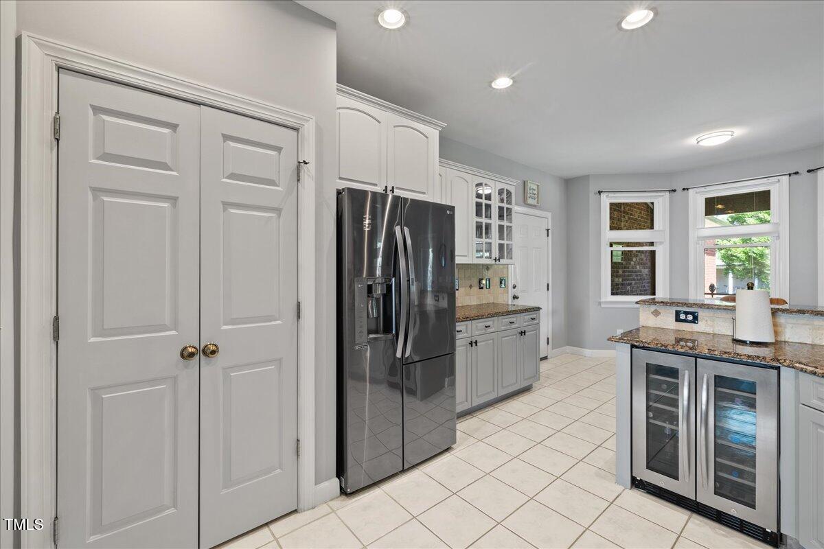 1005 Bellewood Farms Road Raleigh, NC 27603 - Photo 32 of 61 a kitchen with stainless steel appliances a refrigerator and a sink