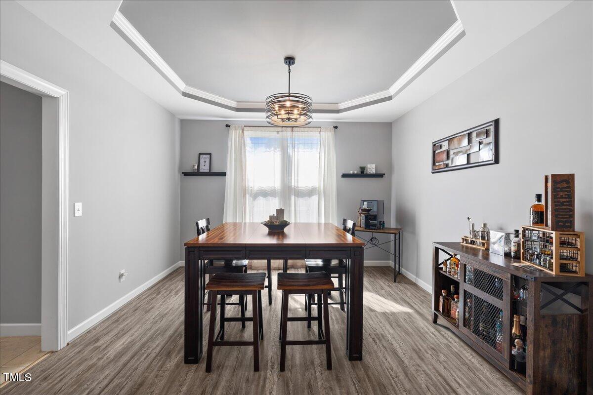 1005 Bellewood Farms Road Raleigh, NC 27603 - Photo 34 of 61 a view of a dining room with furniture window and wooden floor