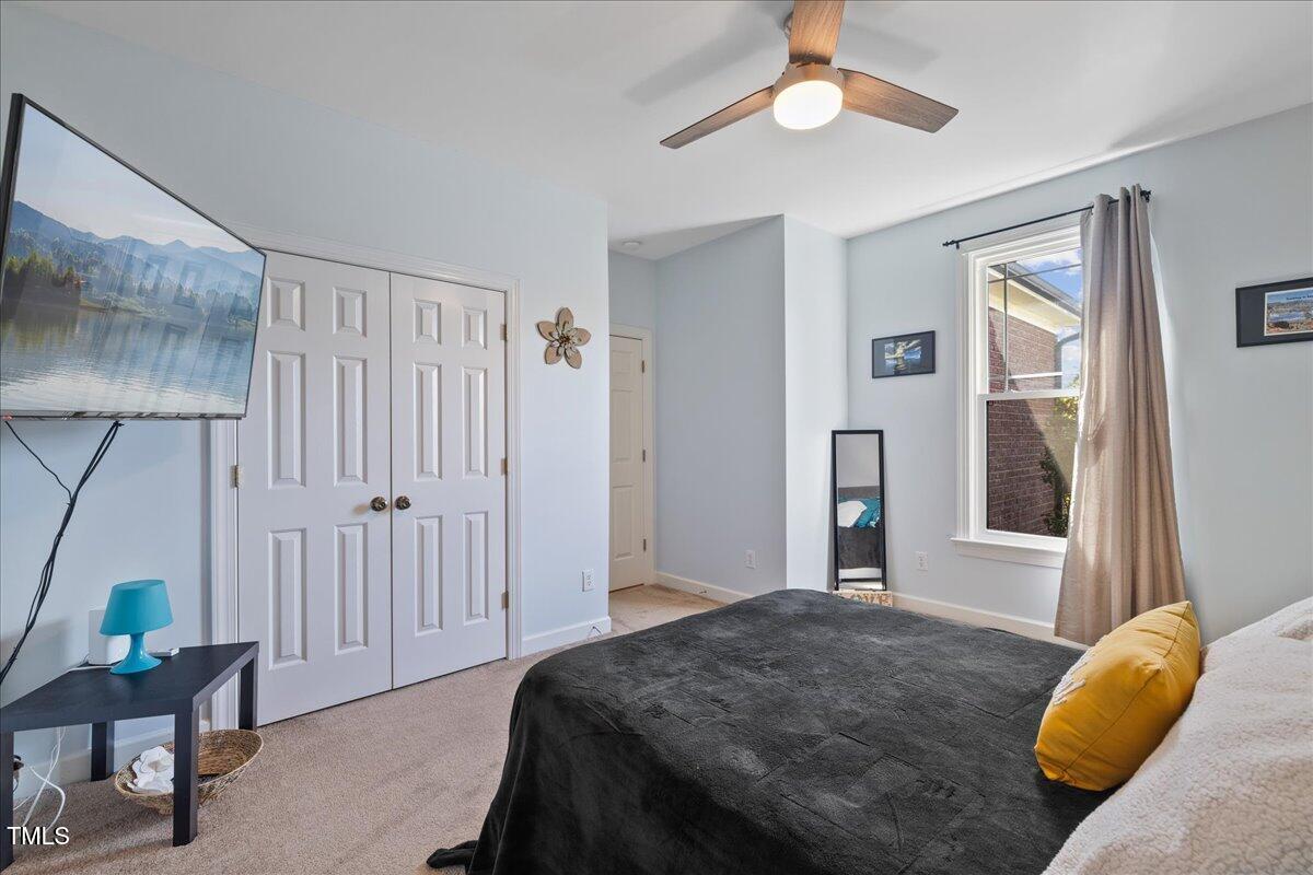 1005 Bellewood Farms Road Raleigh, NC 27603 - Photo 39 of 61 a bedroom with a bed and a chandelier