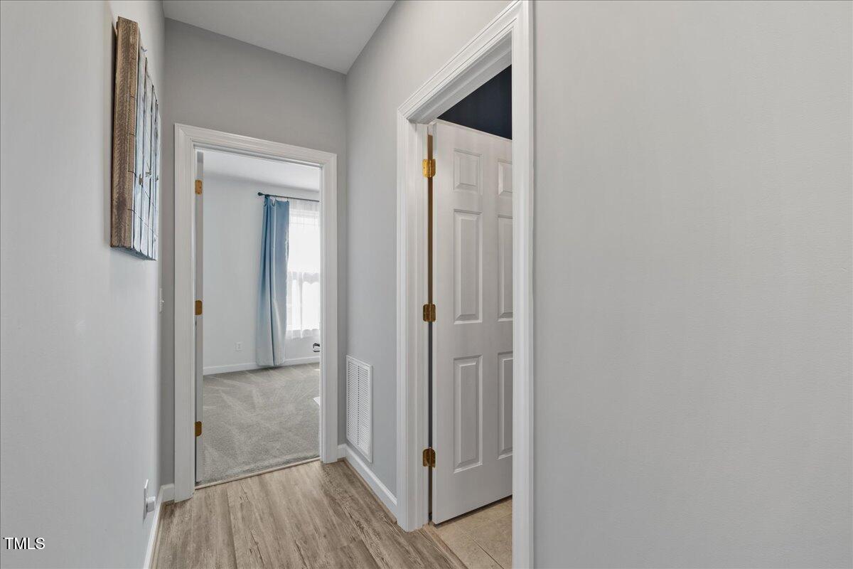 1005 Bellewood Farms Road Raleigh, NC 27603 - Photo 40 of 61 a view of a hallway with wooden floor