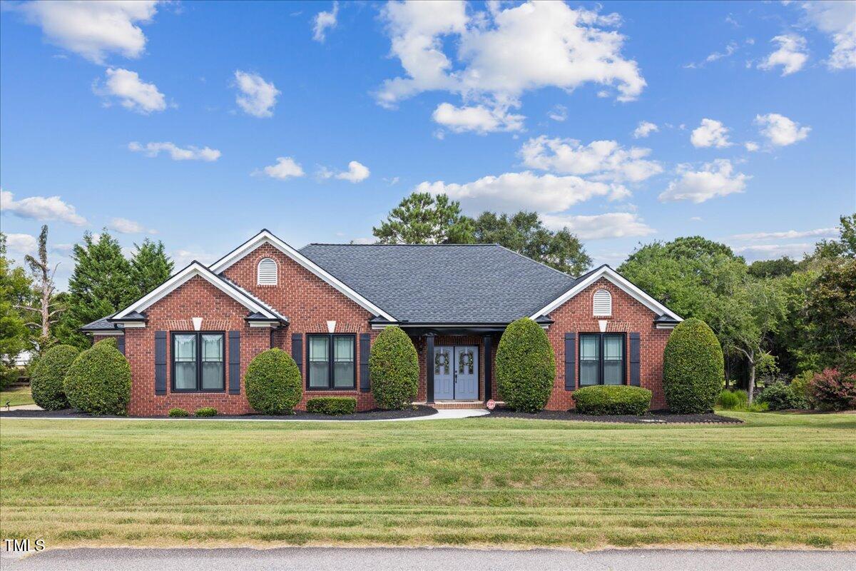 1005 Bellewood Farms Road Raleigh, NC 27603 - Photo 4 of 61 a front view of a house with a garden