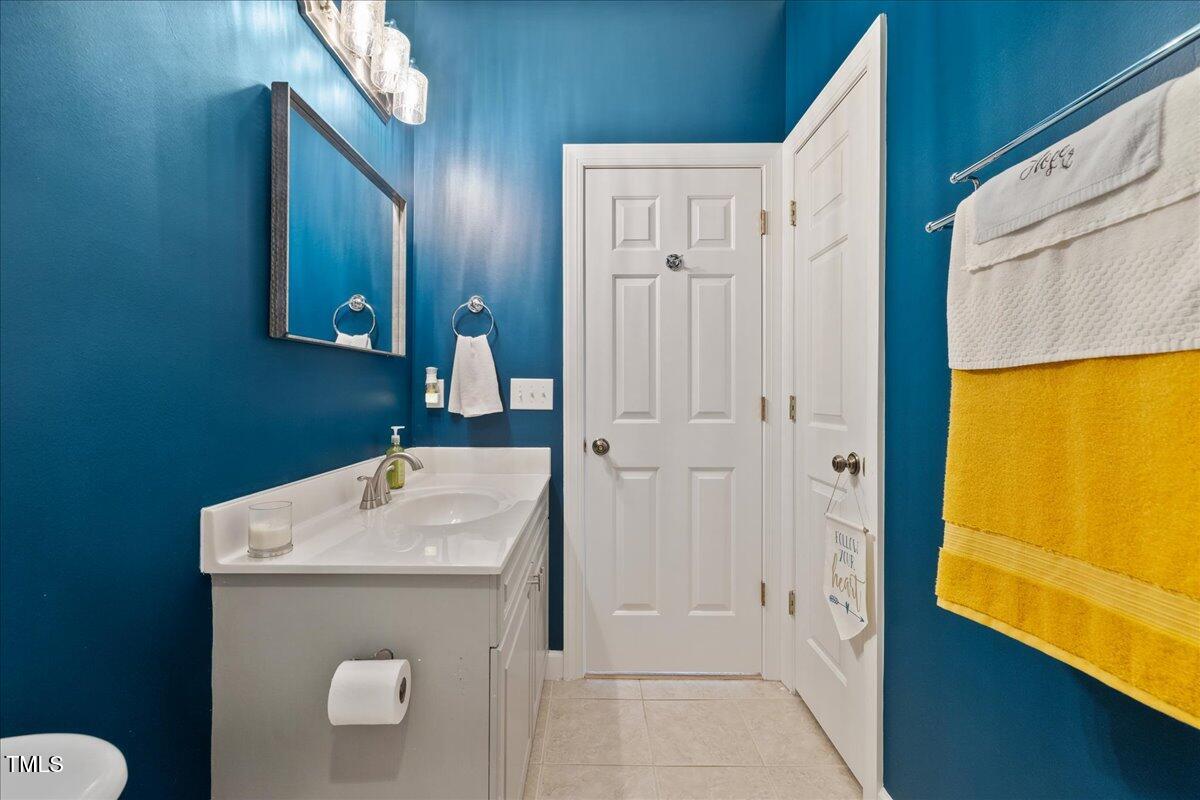1005 Bellewood Farms Road Raleigh, NC 27603 - Photo 42 of 61 a bathroom with a sink a toilet and shower