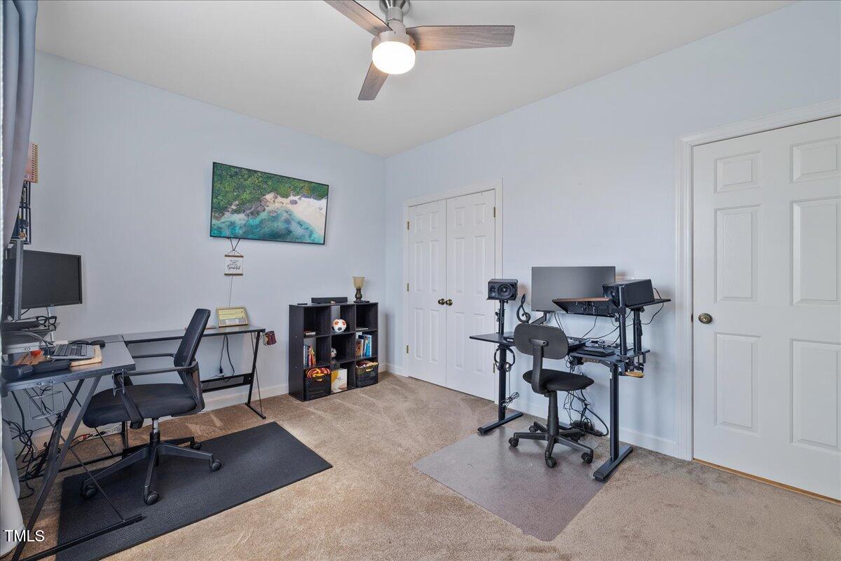 1005 Bellewood Farms Road Raleigh, NC 27603 - Photo 44 of 61 a view of a workspace with furniture and a window