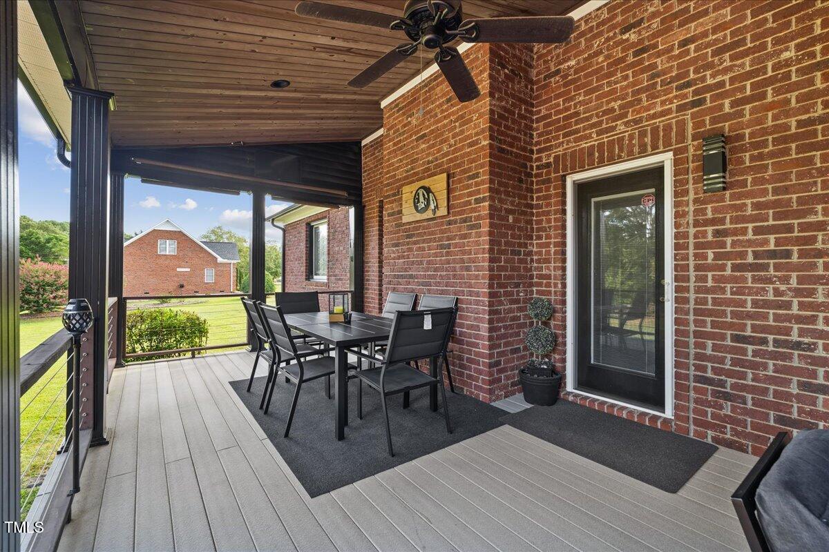 1005 Bellewood Farms Road Raleigh, NC 27603 - Photo 51 of 61 a view of a patio with table and chairs floor to ceiling window with wooden floor
