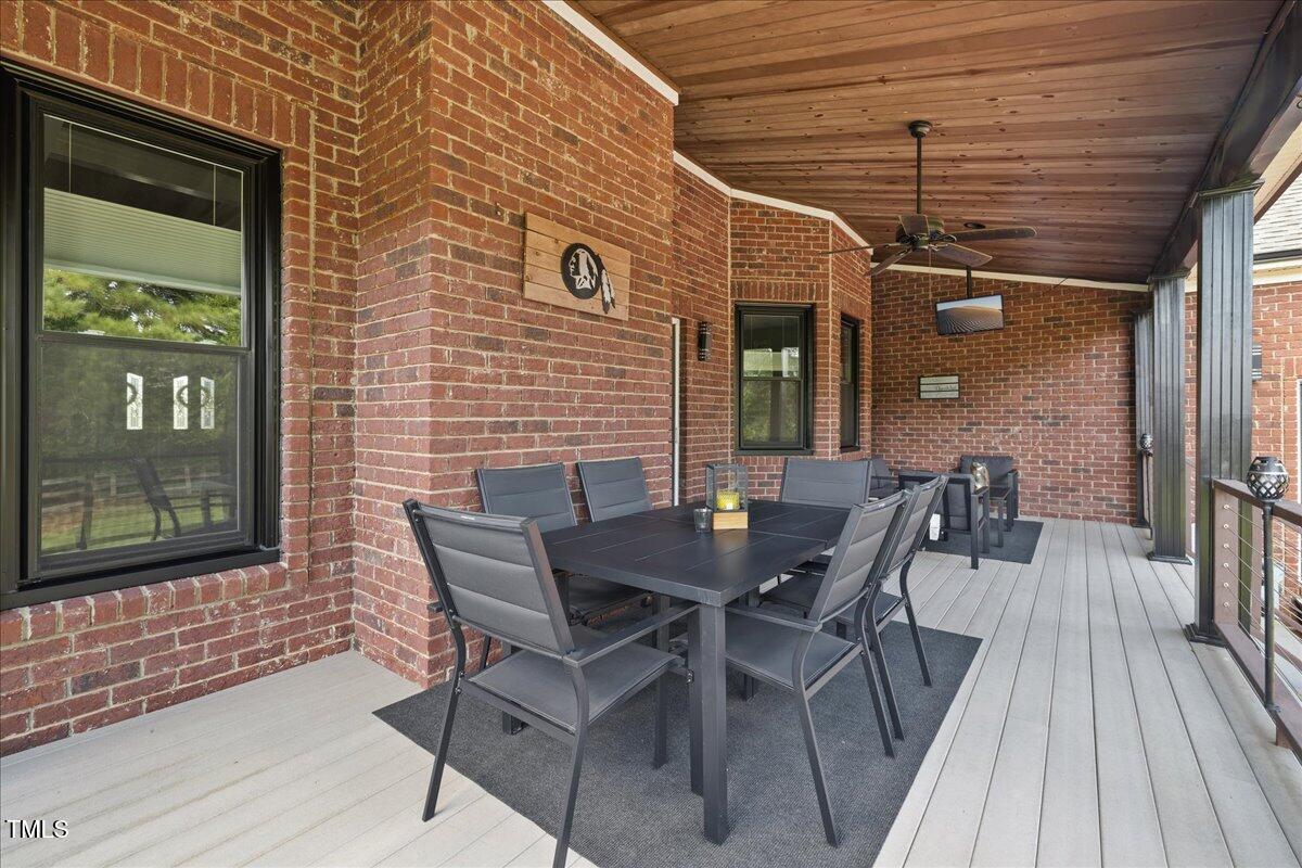1005 Bellewood Farms Road Raleigh, NC 27603 - Photo 52 of 61 a patio with table and chairs and potted plants