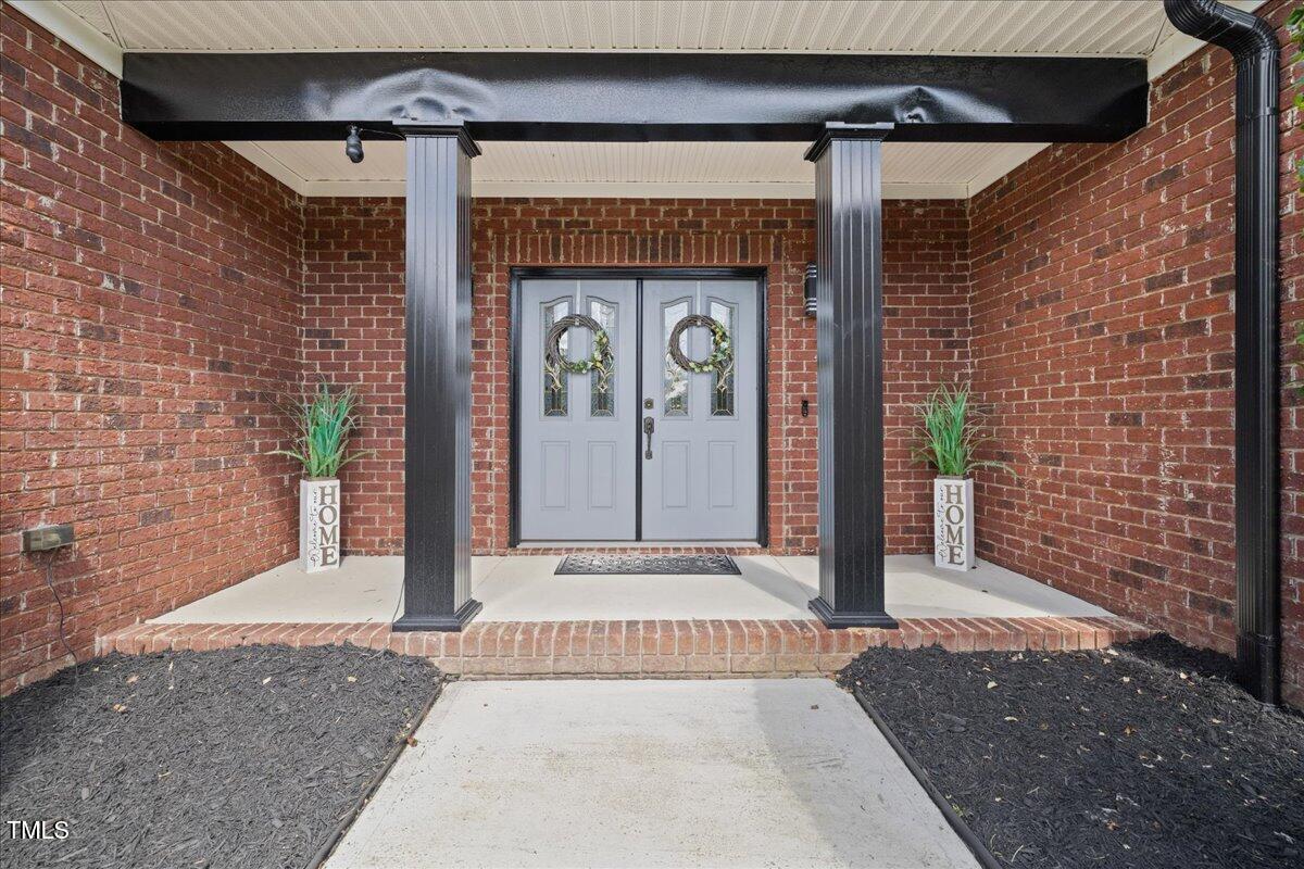 1005 Bellewood Farms Road Raleigh, NC 27603 - Photo 9 of 61 a front view of a house with a porch