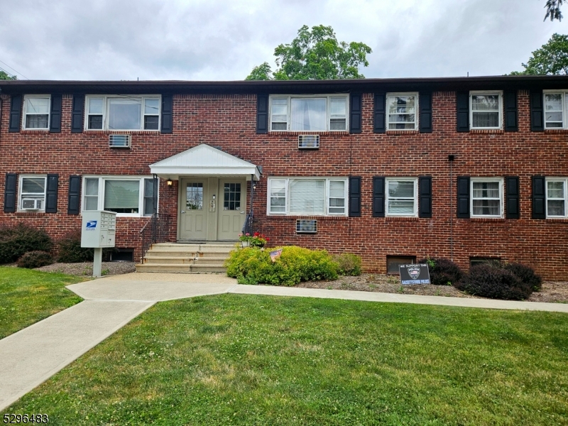 201 Vail Street, Unit 1B Hackettstown, NJ 07840 - Photo 12 of 12 a front view of a house with a yard and potted plants