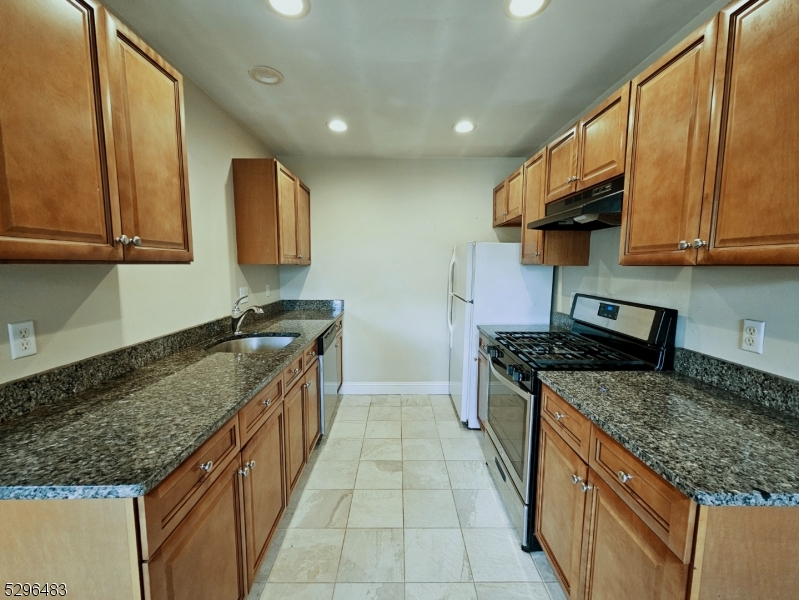 201 Vail Street, Unit 1B Hackettstown, NJ 07840 - Photo 6 of 12 a kitchen with stainless steel appliances granite countertop a stove a sink and a microwave