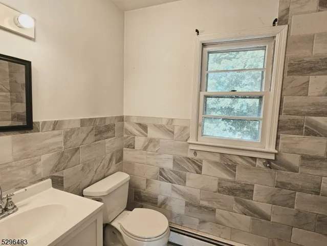 a white toilet sitting next to a bathroom sink