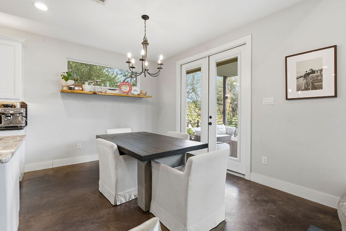 10012 Janet Loop Dripping Springs, TX 78620 - Photo 11 of 38 a view of a dining room with furniture and chandelier