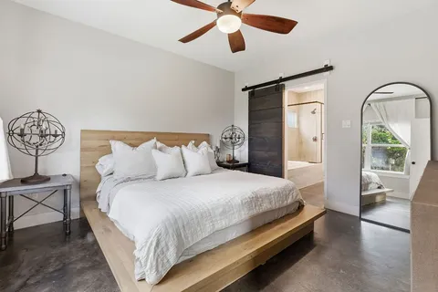 a bedroom with bed and a chandelier