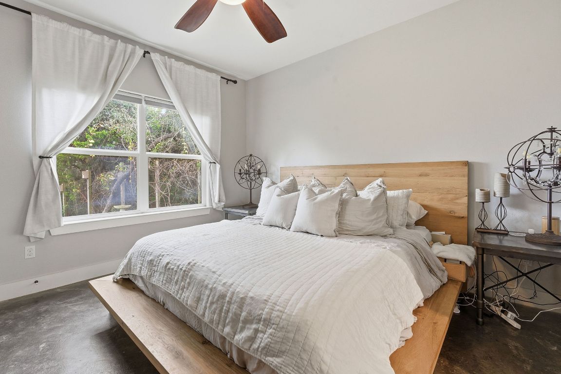 10012 Janet Loop Dripping Springs, TX 78620 - Photo 14 of 38 a bedroom with a bed and a window