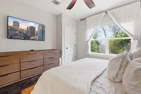 a bedroom with a bed and a window