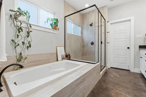 a bathroom with a tub and a shower