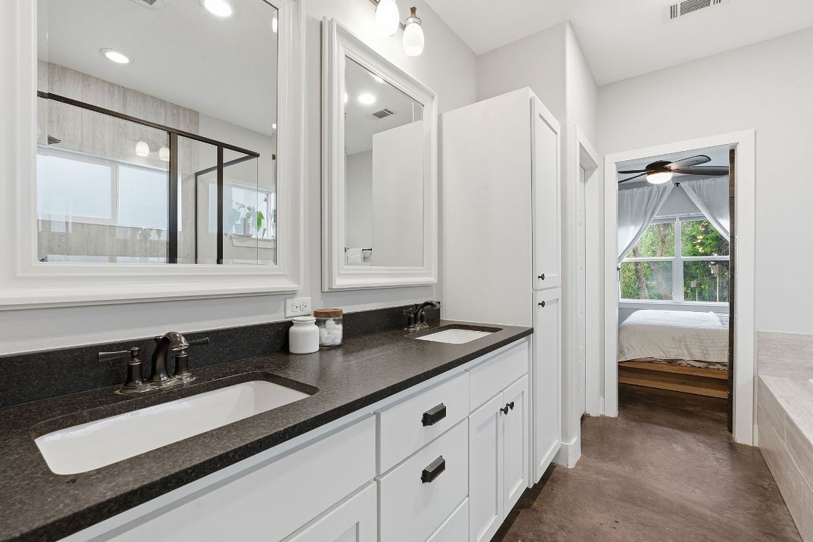 10012 Janet Loop Dripping Springs, TX 78620 - Photo 17 of 38 a en suite bathroom with double sink and a mirror