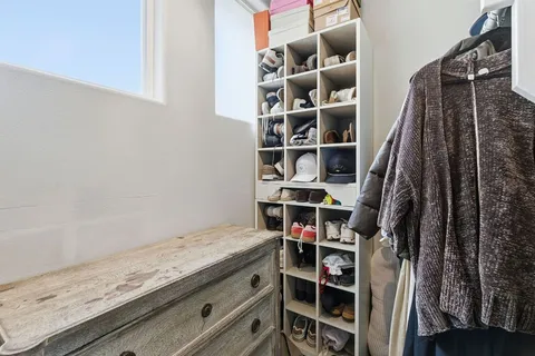 a view of walk in closet with empty racks