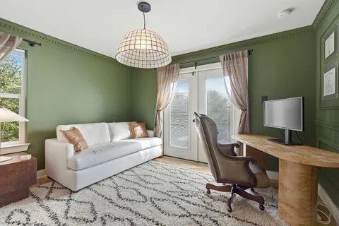 a living room with furniture and a chandelier