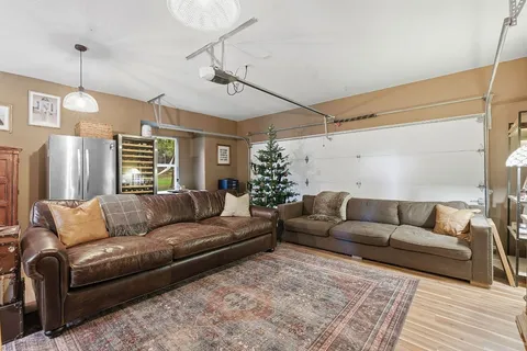a living room with furniture and a chandelier