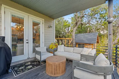 a living room with furniture and a floor to ceiling window